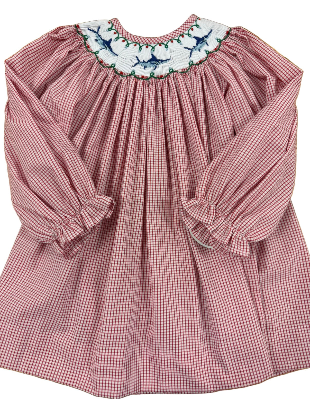 A long-sleeve baby smocked dress in a red and white gingham pattern, featuring a white smocked marlin design with embroidered blue and green marlin motifs.