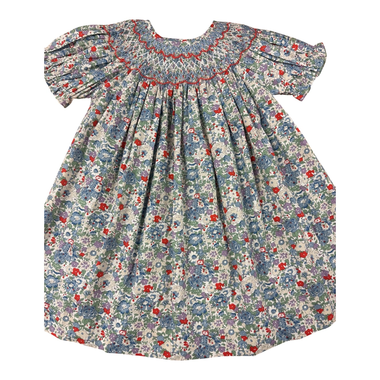 A baby girl's smocked dress with short puff sleeves, featuring a blue, red, and white floral print on a light background.