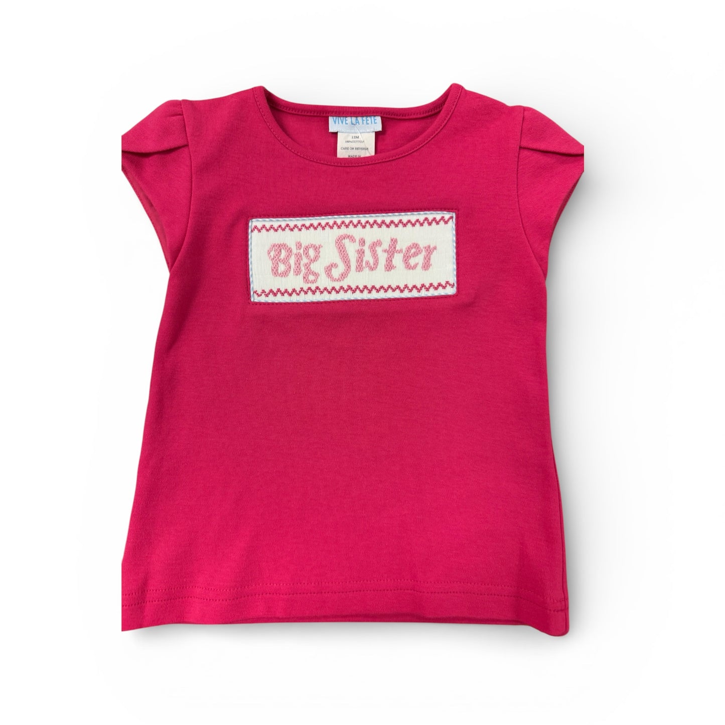 Pink smoked shirt with 'Big Sister' text on a white background