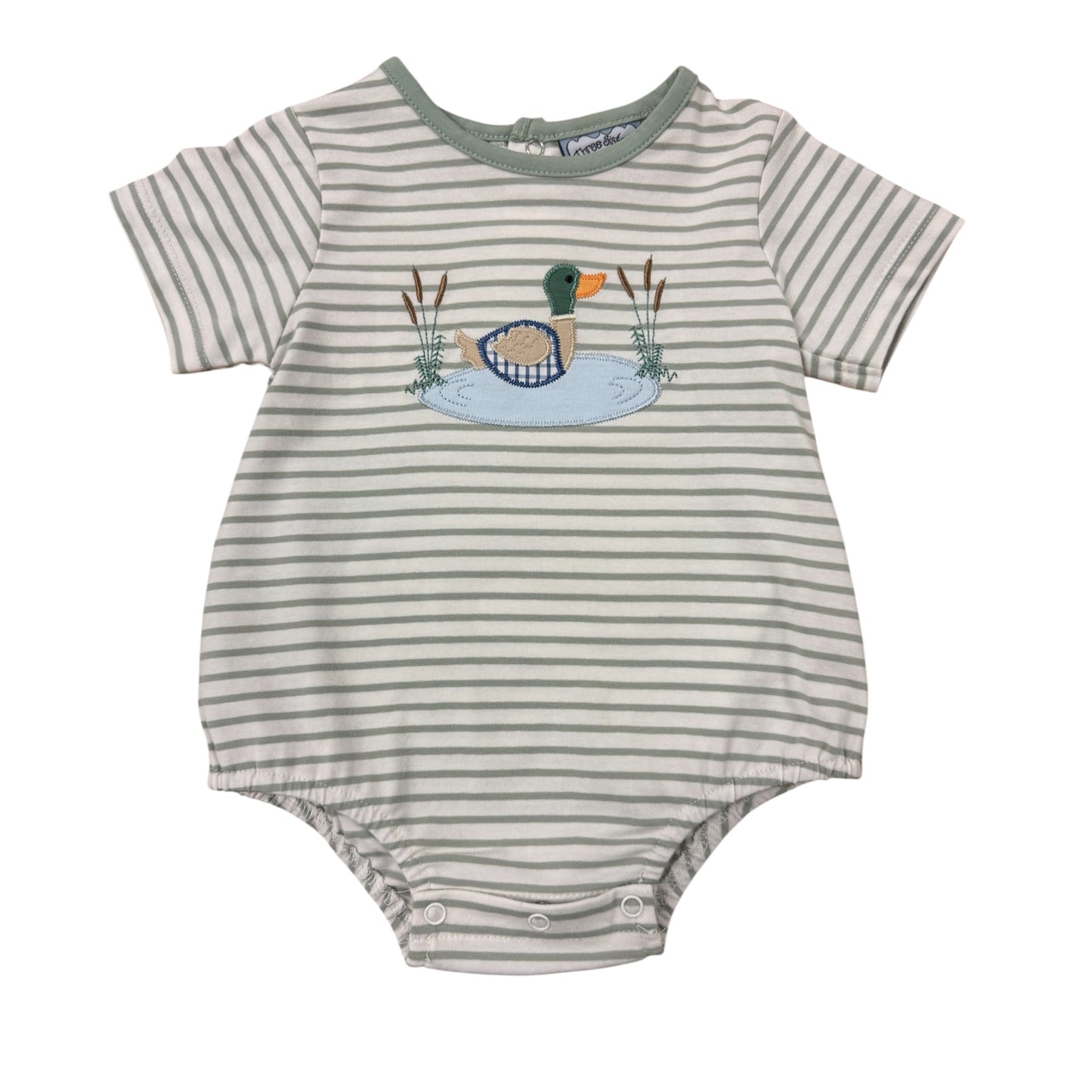 Striped baby romper with duck design on a tan background