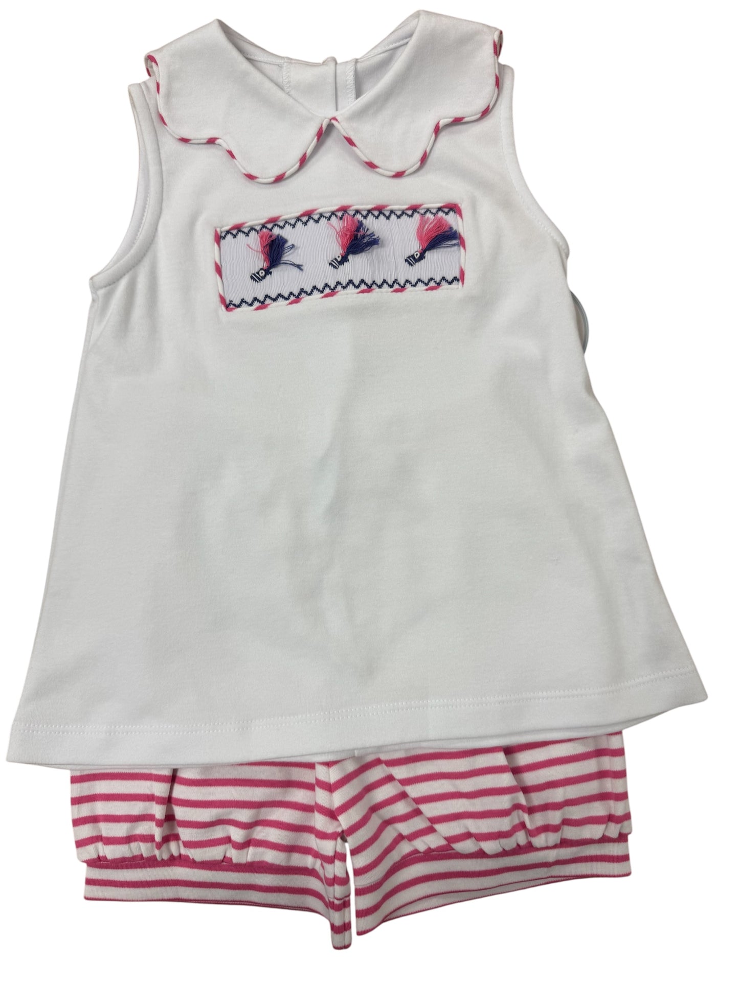 White smocked navy and pink fishing lures on a white top with pink and white striped shorts