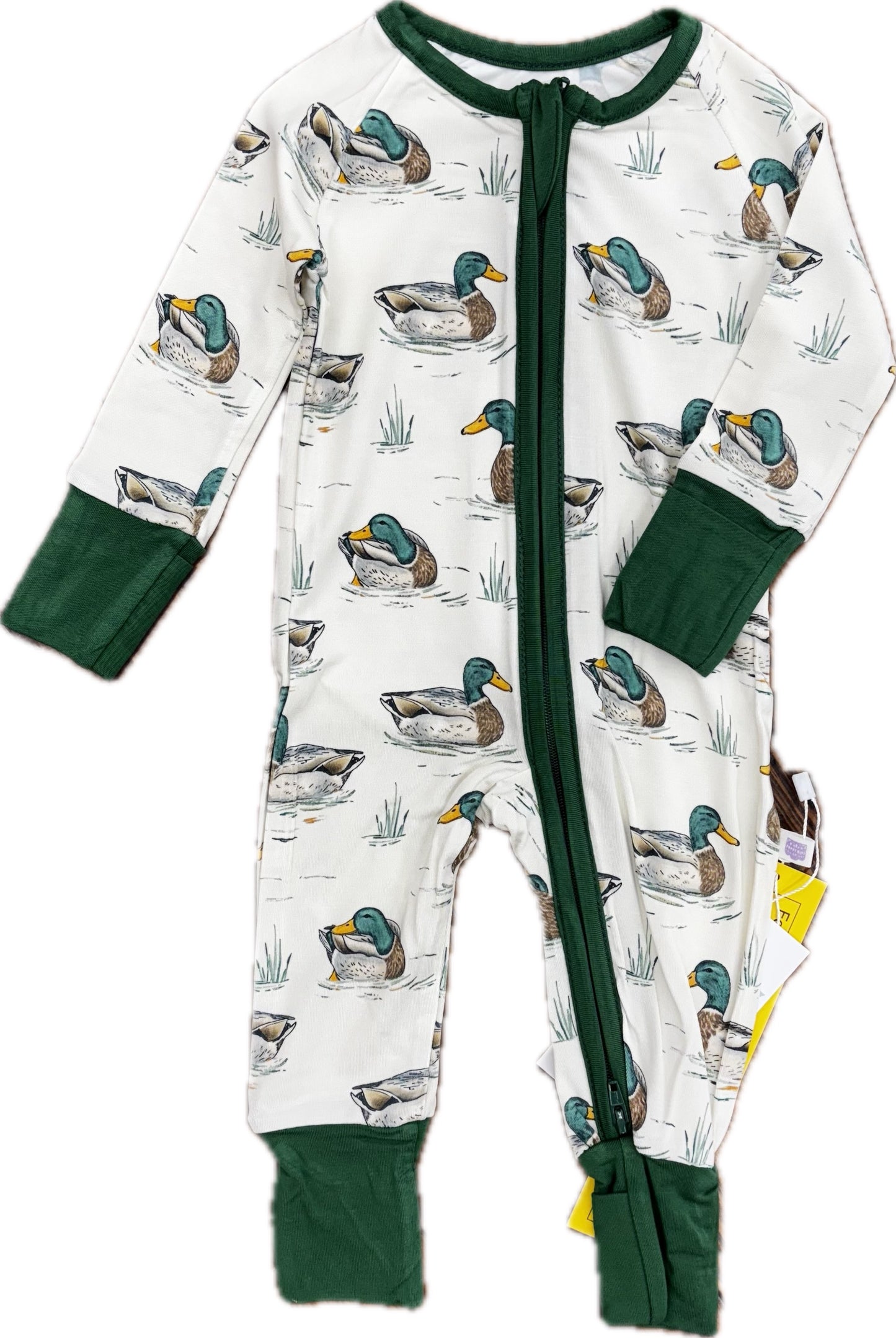 Zipper romper with green trim and a duck pattern.