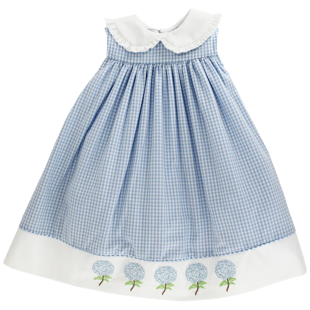 Blue checkered dress with white collar and hem featuring floral hydrangea on the bottom.
