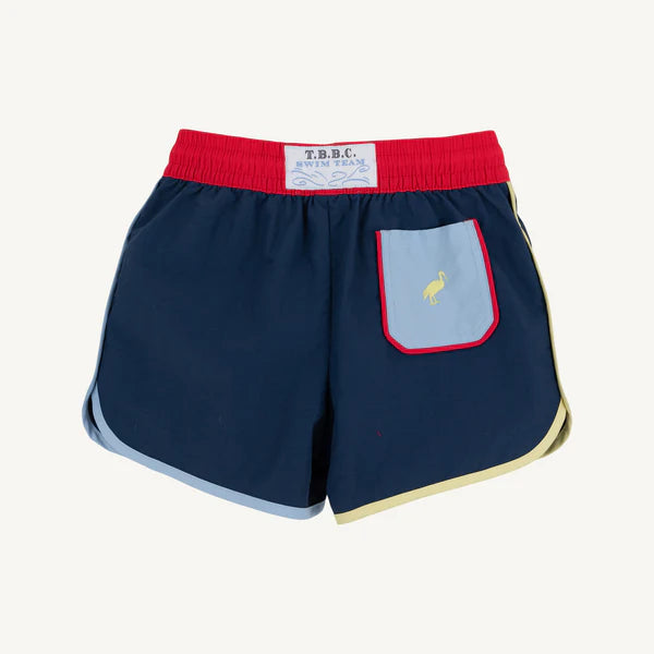 Navy swim shorts with a red waistband and light blue pocket