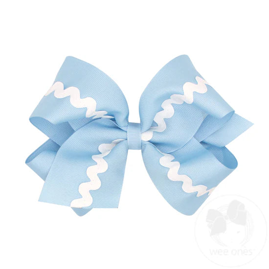 Light blue hair bow with white ric rac trim.
