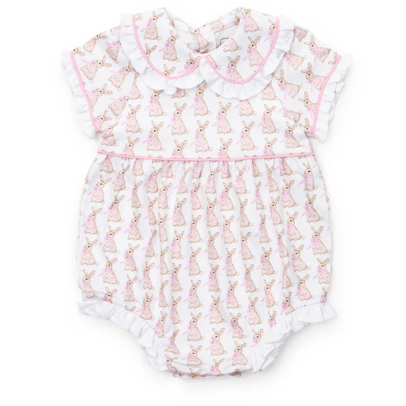 Spring bubble with bunnies with pink bows on a cream background with pink trim and a ruffled collar, leg and sleeve.