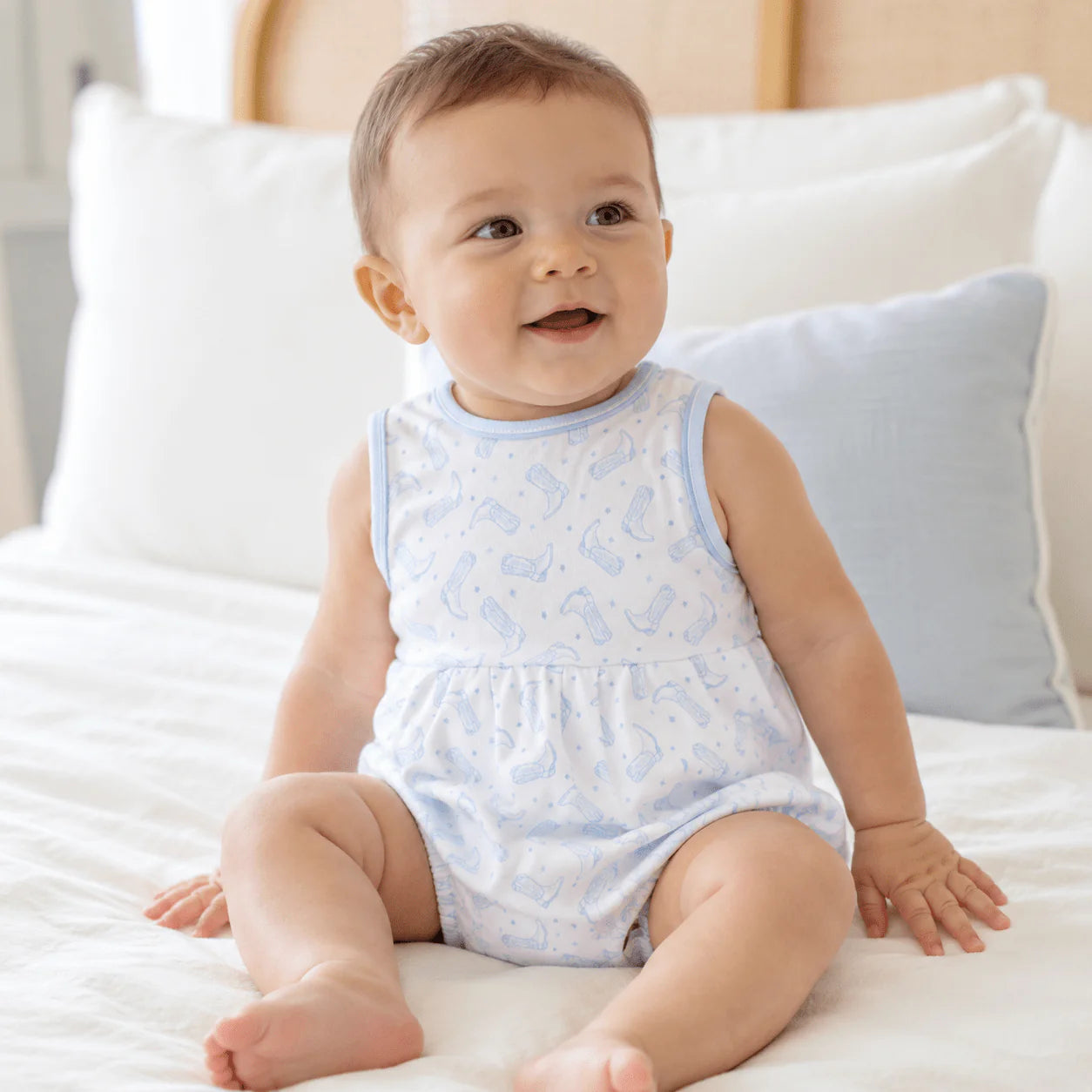 Sleeveless bubble with light blue trim and a light blue cowboy boots pattern.