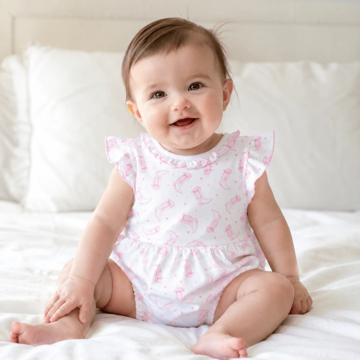 Ruffle trimmed bubble with a pink cowboy boot pattern.