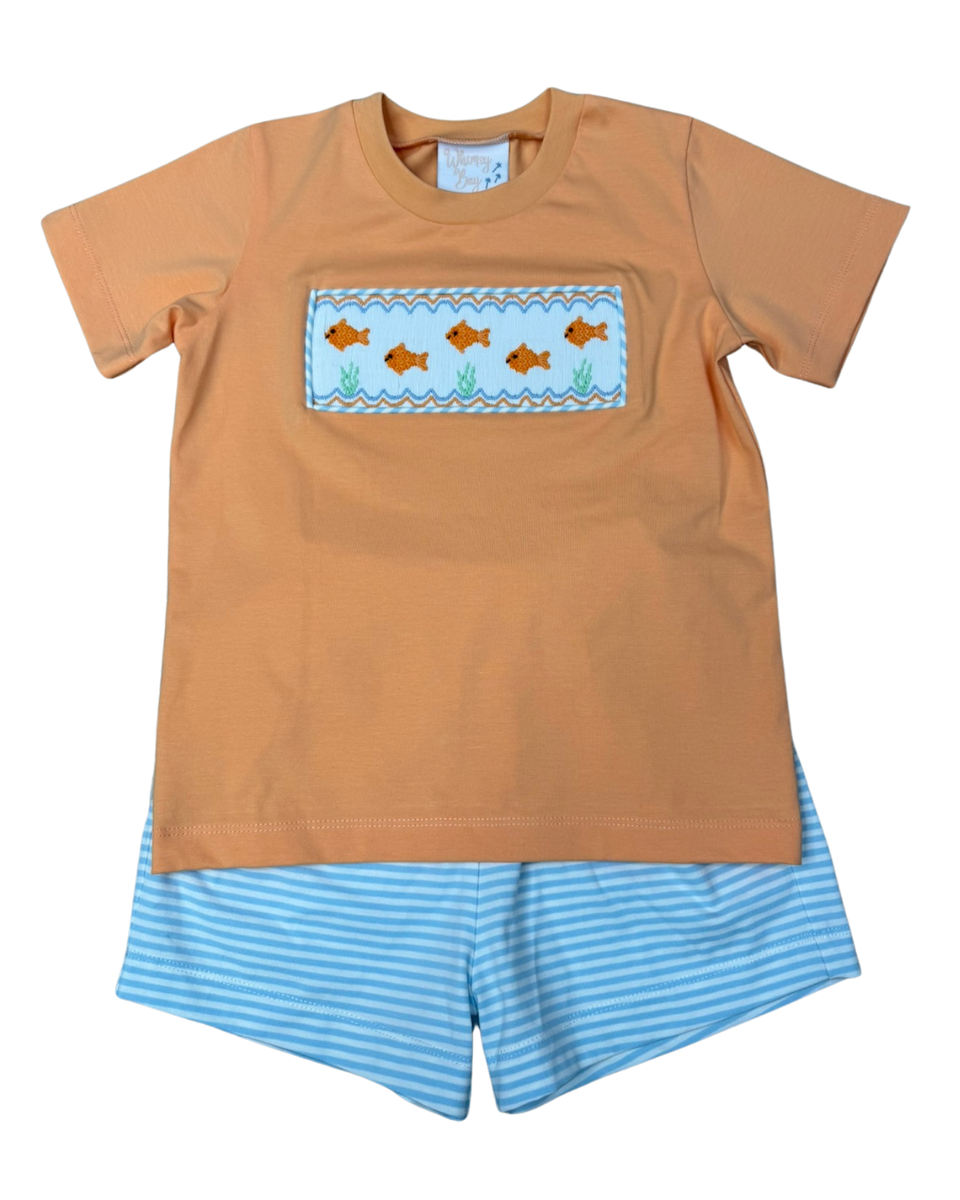 Short sleeve orange shirt with goldfish embroidered smocking, and blue striped shorts.