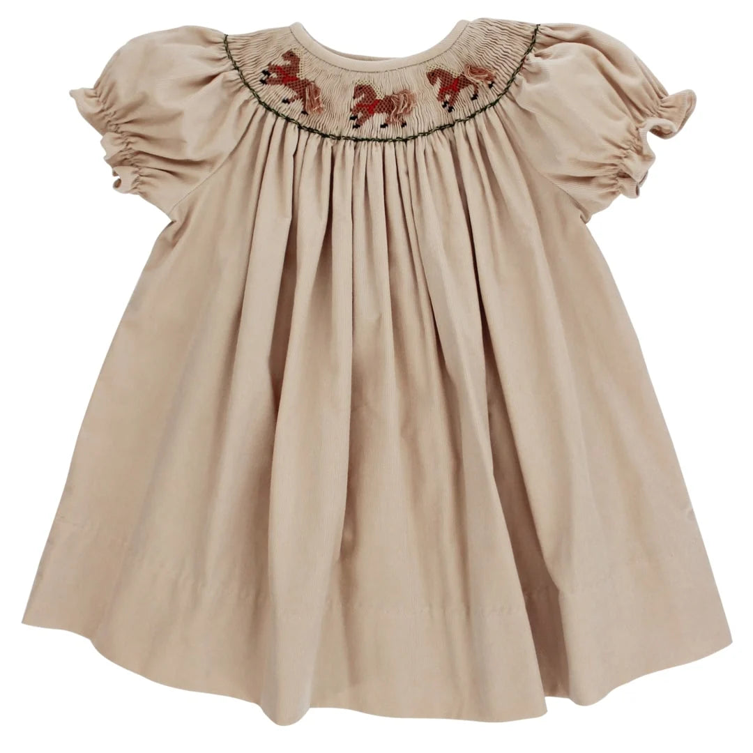 A beige baby dress with short puff sleeves, a smocked bodice, and embroidered brown horses around the neckline, shown on a plain white background.