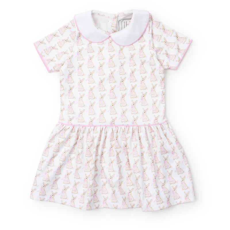 Short sleeve spring dress with bunnies with pink bows on a cream background, drop waist, pink trim and white collar.