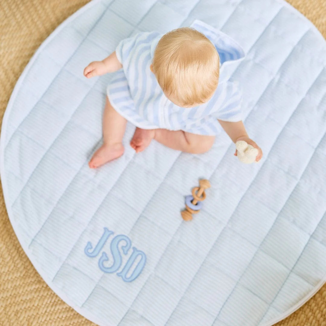 Round tummy time mat with blue checkered print