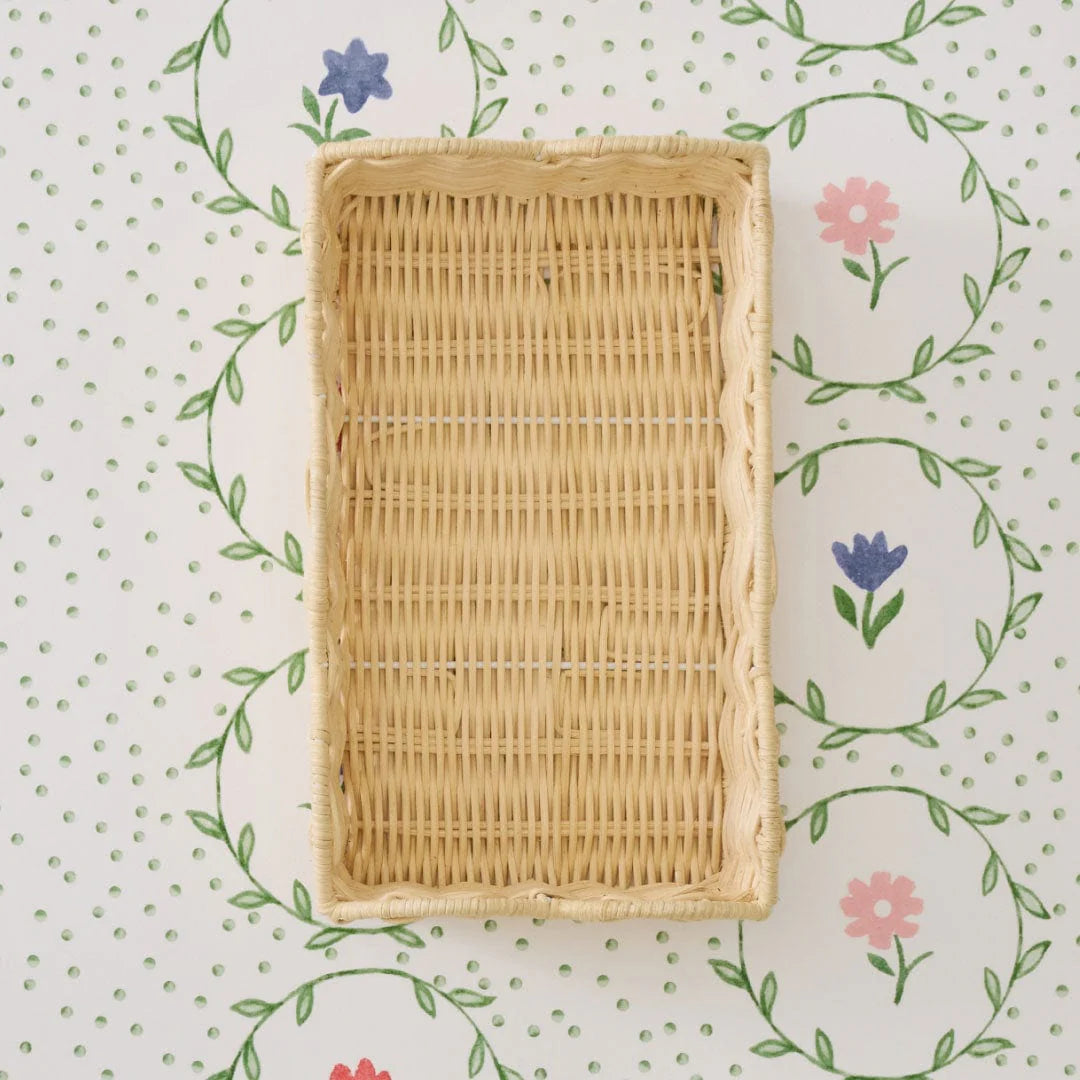 Woven rectangular napkin tray on a floral-patterned background