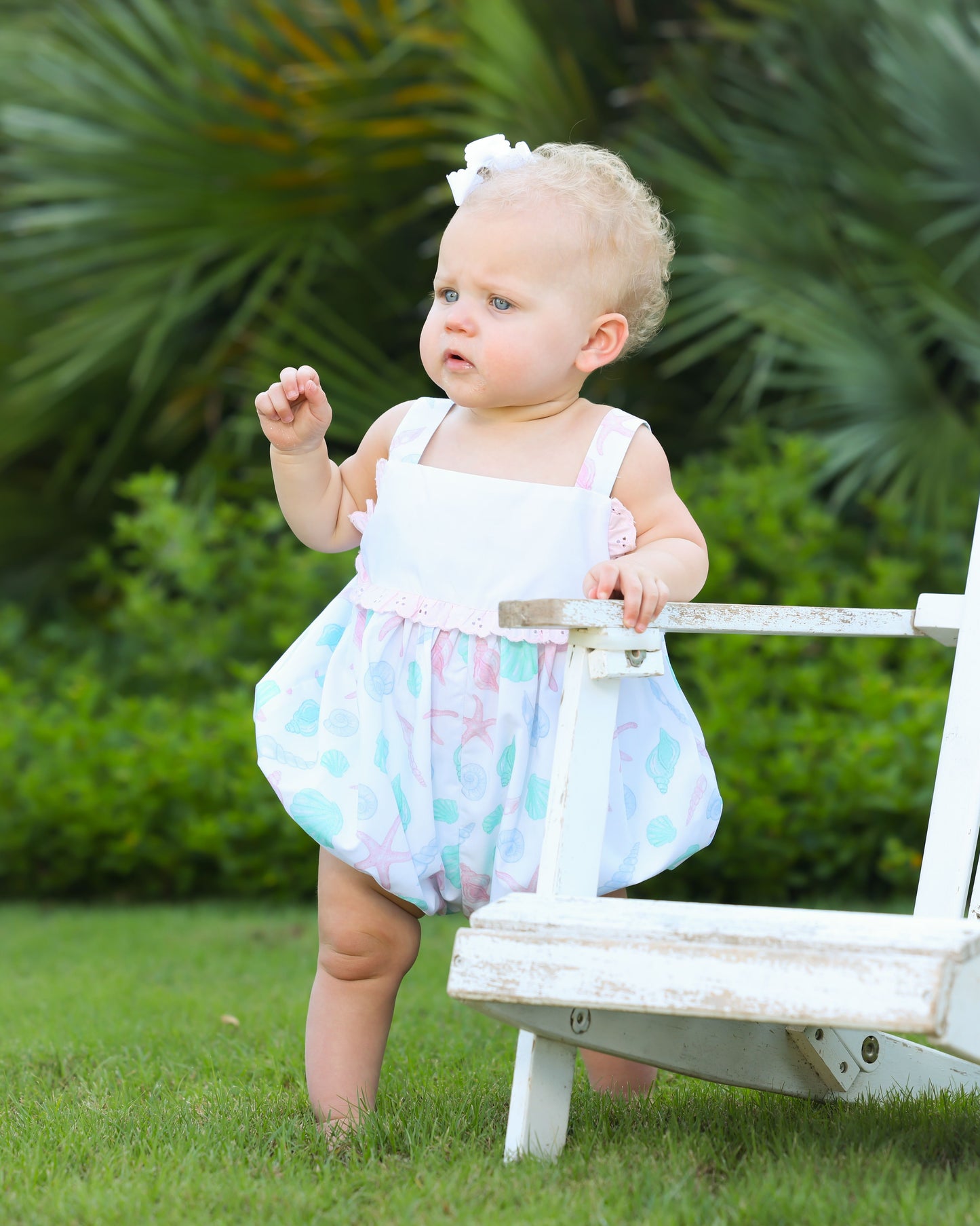 White bubble with pink/green seashell print on bottom half with eyelet trim in middle