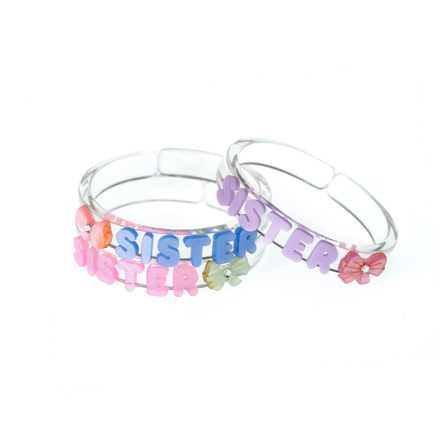 Three clear bangles with 'SISTER' letters and colorful accents on a white background