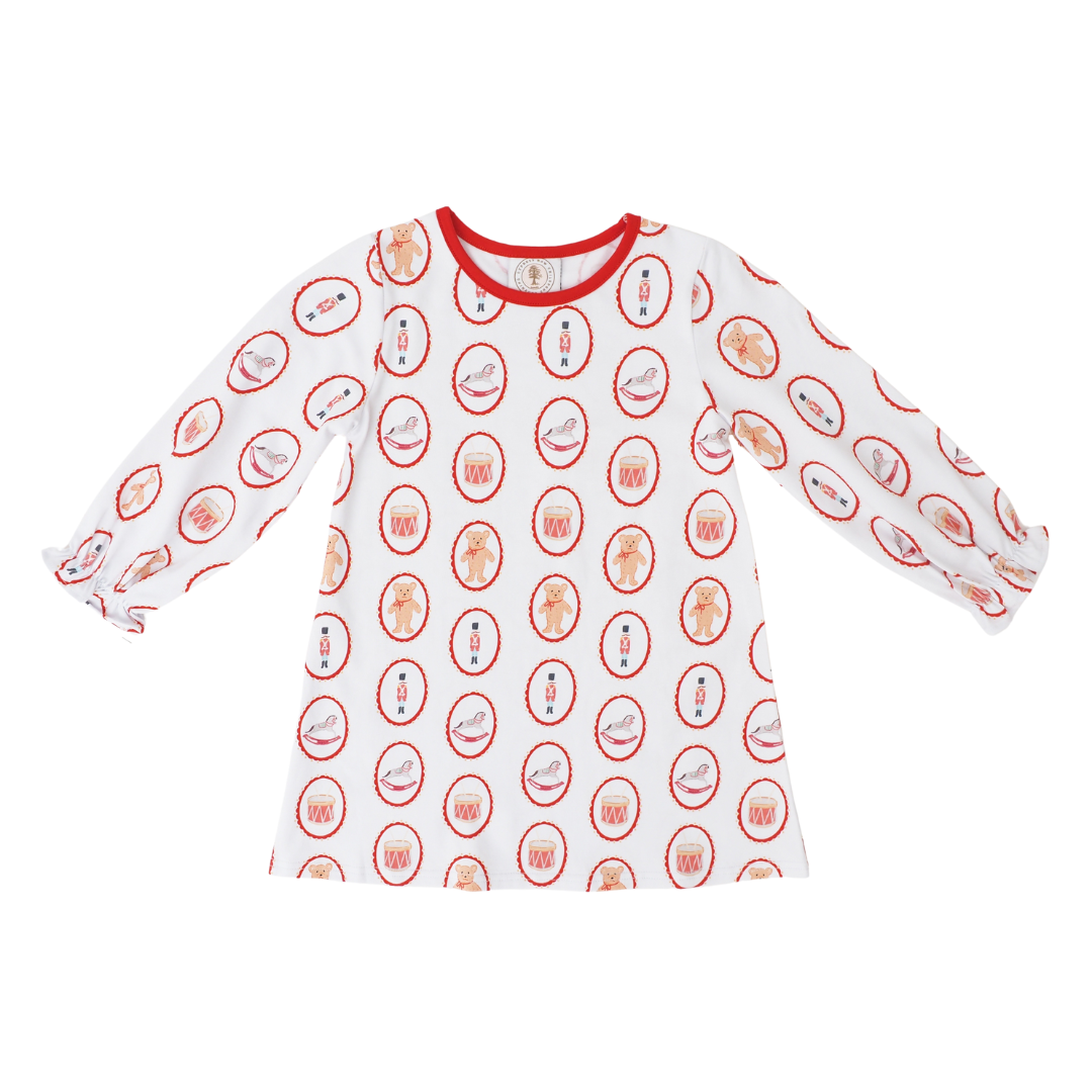 A white long-sleeve t-shirt with a red crew neck collar, featuring an all-over repeating pattern of christmas toys