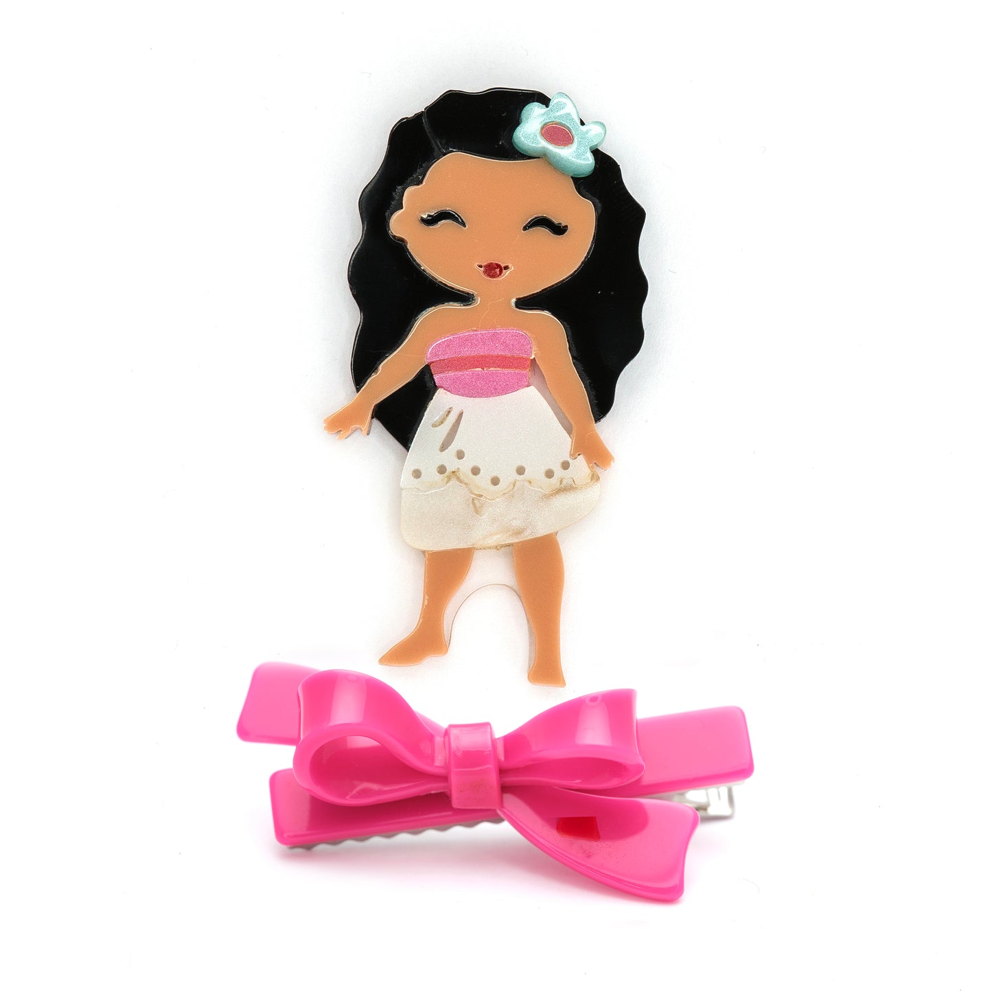 Hair clip with a pink bow and a small figurine of a girl with black hair and a white dress