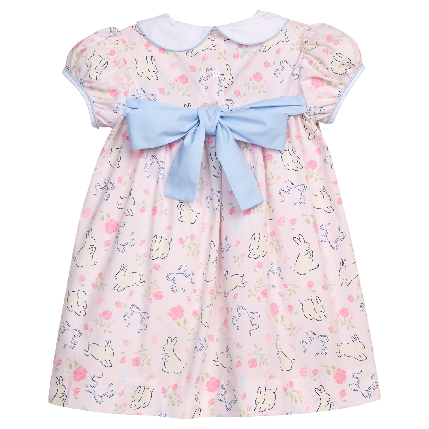 Children's dress with bunny pattern and blue bow on a pink background