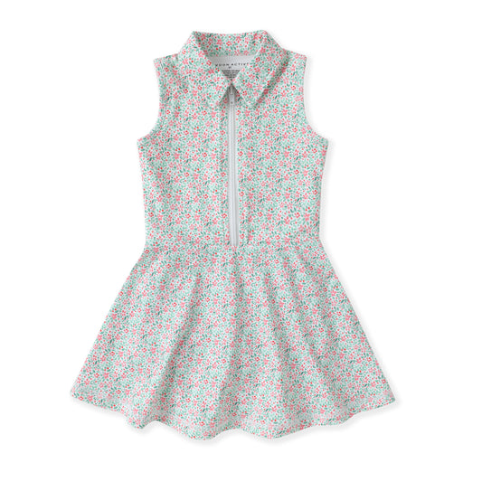 A sleeveless children's tennis dress with a small-scale floral print in red, green, and white, featuring a collar, a front zipper, and a flared skirt.