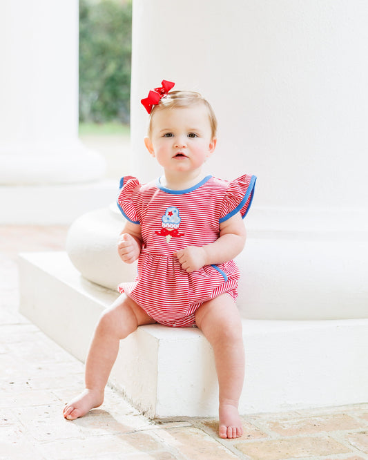 Baby Bubble with red and white striped with a bow sitting on an ice cream cone. 