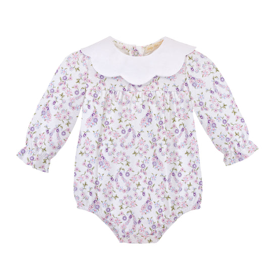 A baby long-sleeve romper with a white floral and paisley print, featuring a white scalloped Peter Pan collar and ruffled cuffs, shown on a plain white background.