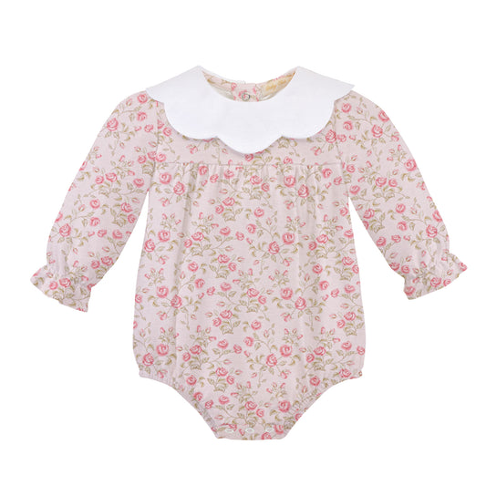 A baby long-sleeve romper with a pink and green floral print on a light beige background, featuring a contrasting white scalloped Peter Pan collar.