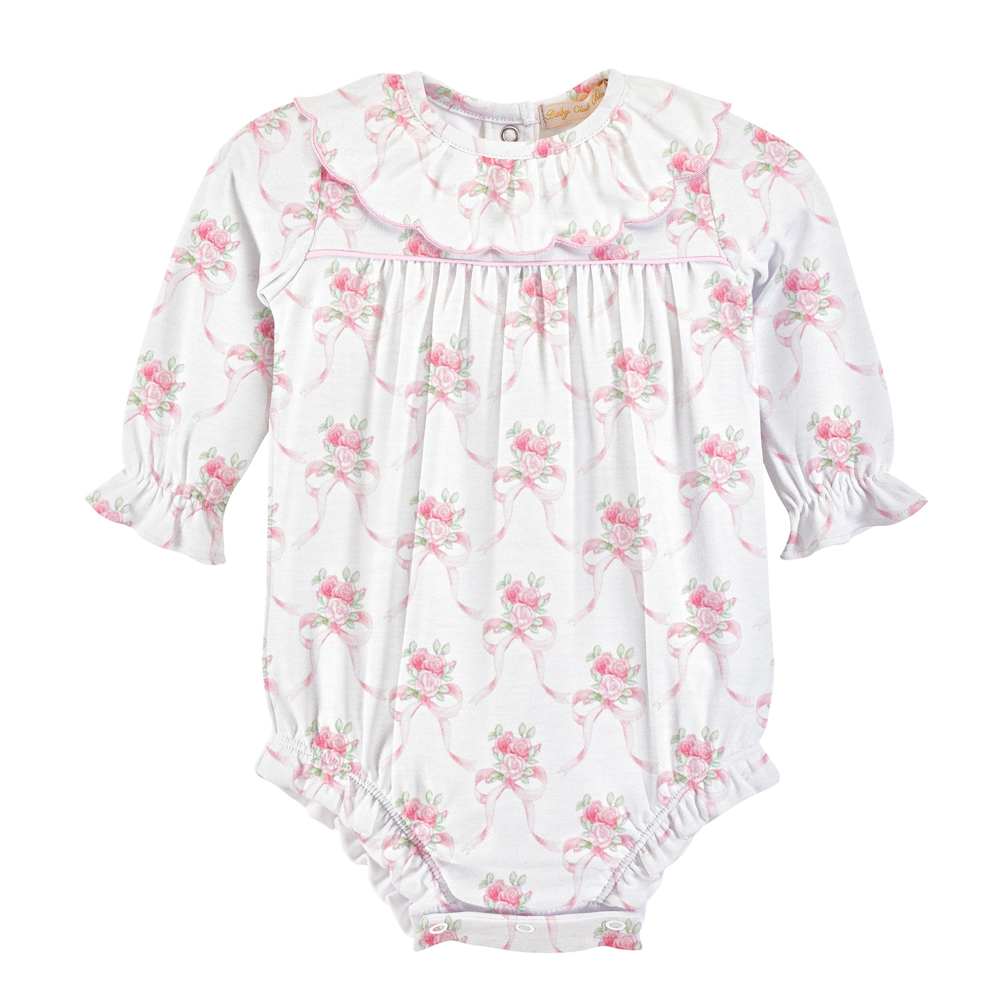 A white long-sleeve baby romper with a pink and green floral print, featuring a ruffled collar, smocked chest, and ruffled cuffs and leg openings.