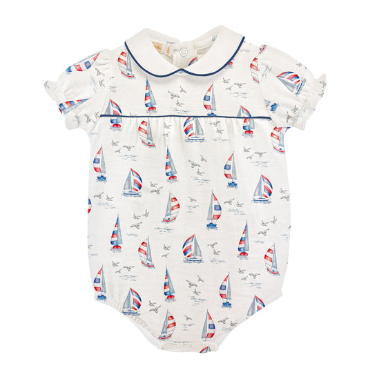 Bubble with a red white and blue sailboat pattern on a white background with a round collar and blue piping.