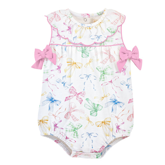 Baby romper with colorful bow pattern, a ruffled collar, pink piping and pink bows.