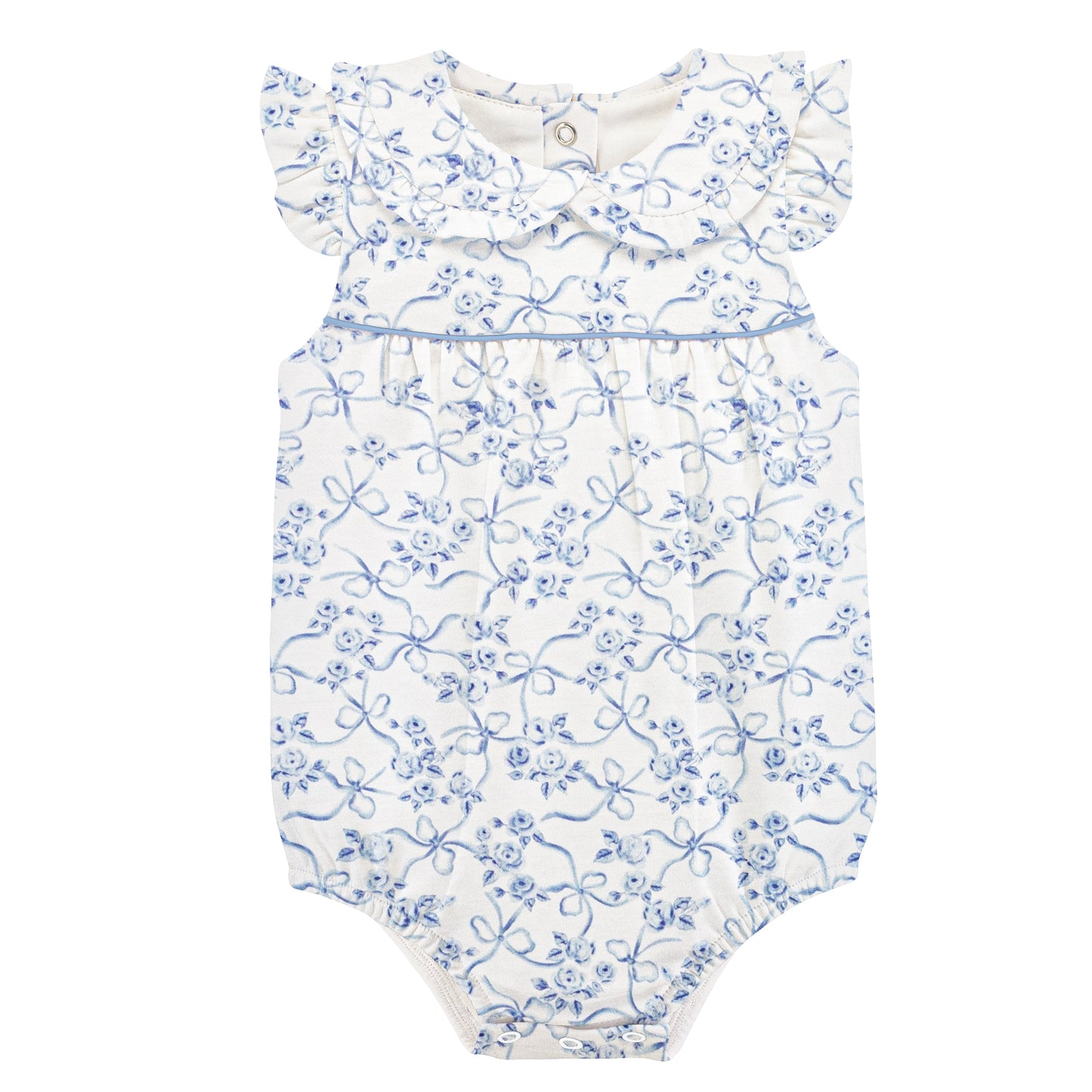 Blue toile bow and flower pattern on a white background, with a ruffle collar and sleeve and blue piping.