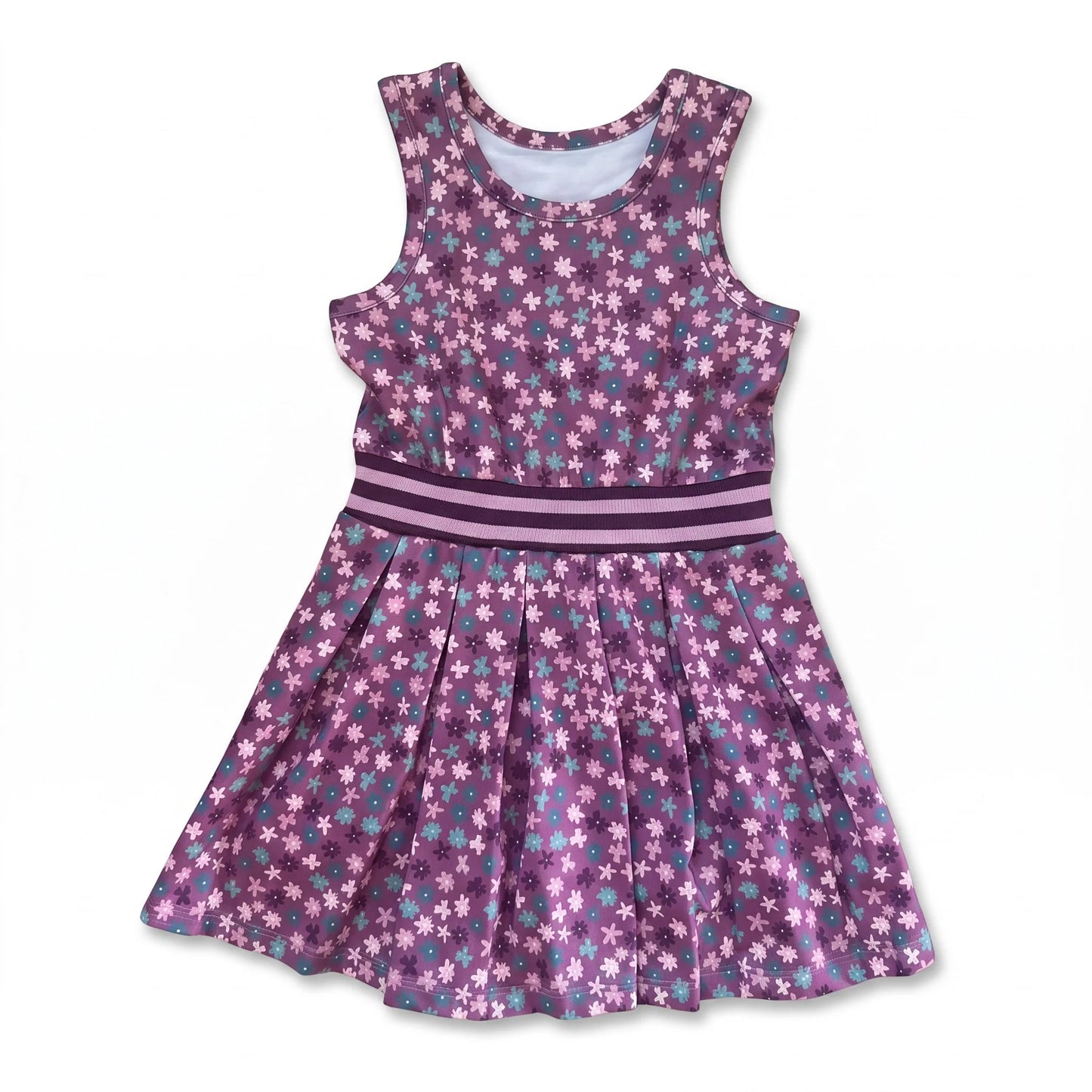A sleeveless purple children's dress with a white and light blue floral pattern, featuring a matching waistband with pink stripes and a pleated skirt, shown on a plain white background.