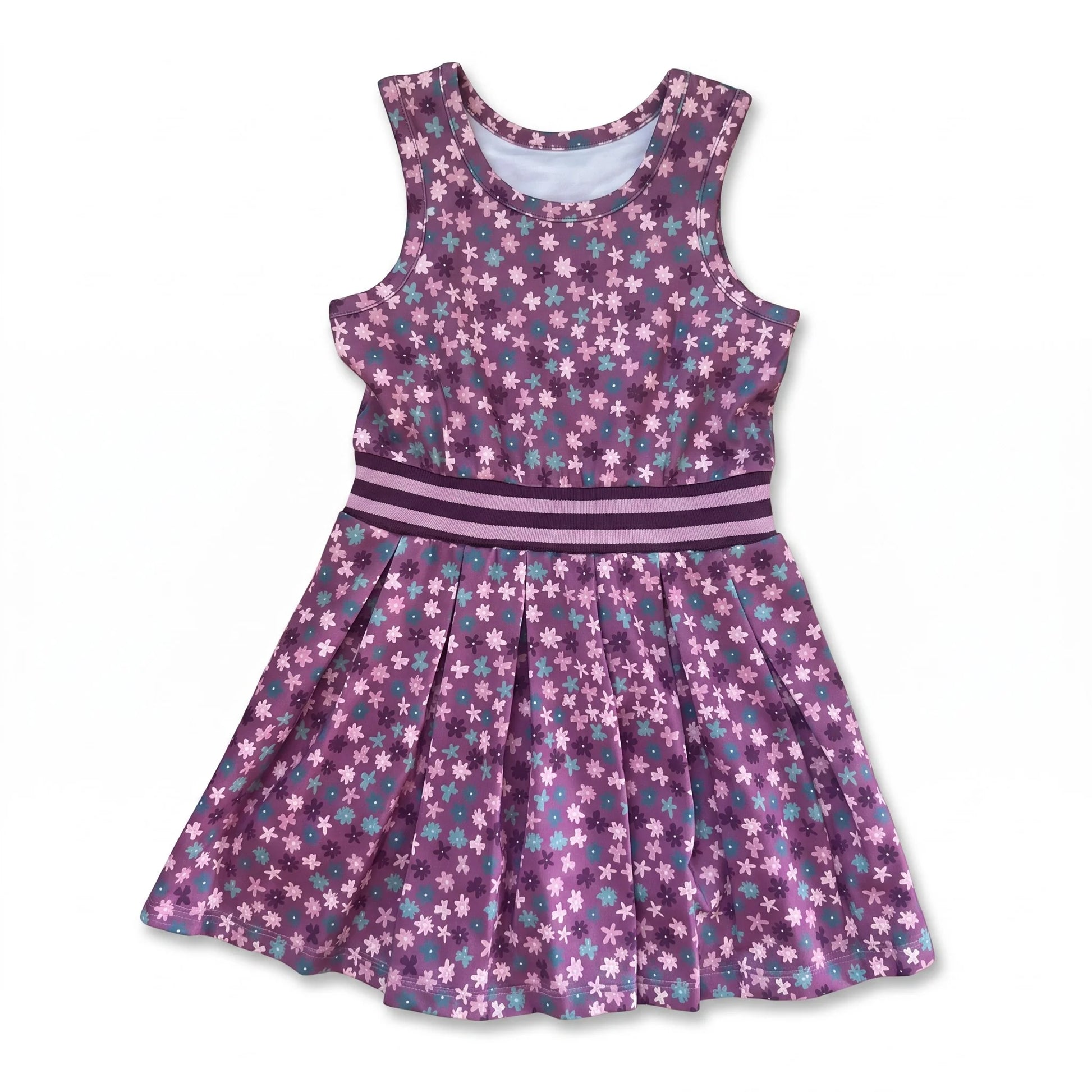 A sleeveless purple children's dress with a white and light blue floral pattern, featuring a matching waistband with pink stripes and a pleated skirt, shown on a plain white background.