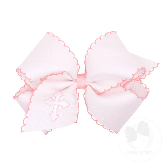 White hair bow with embroidered cross and pink moonstitch edging.