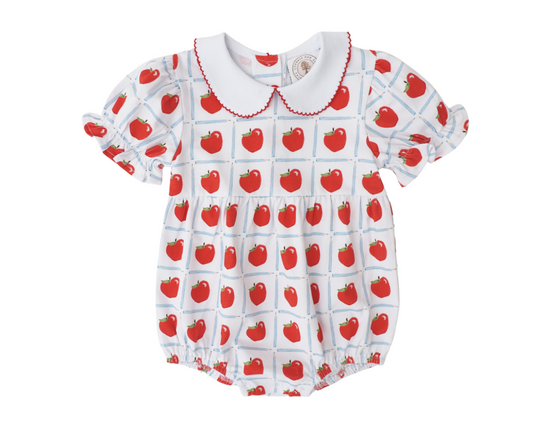 White bubble with red apples inside a blue pencil check pattern, with red scalloped piping around the collar and puffed short sleeves.