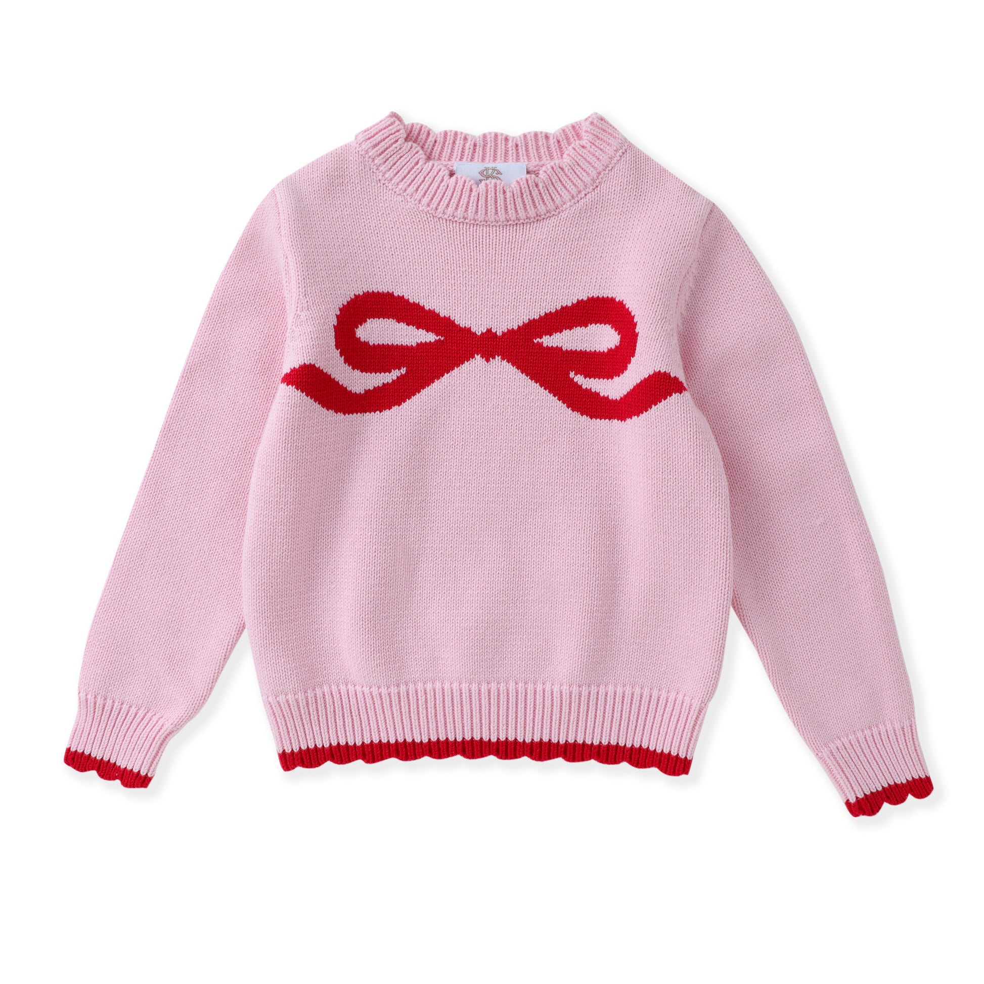 A light pink knit sweater with a red knitted bow motif across the chest and a matching red scalloped trim at the hem and cuffs, shown on a plain white background.