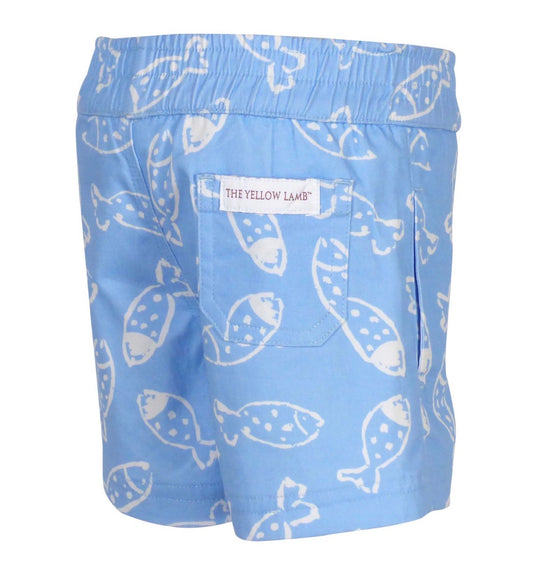 Blue shorts with white fish pattern and 'The Yellow Lamb' label on a white background