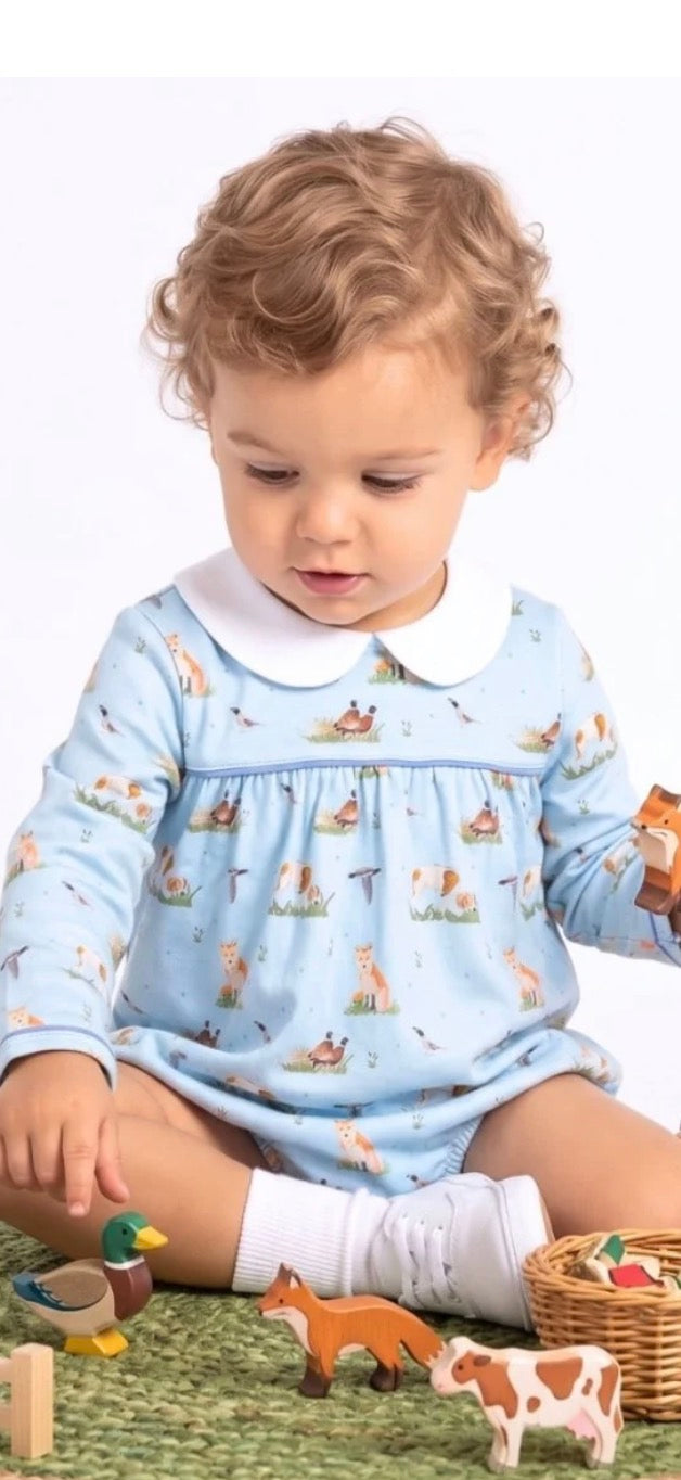 light blue long-sleeve romper with a white Peter Pan collar and a small woodland animal print.