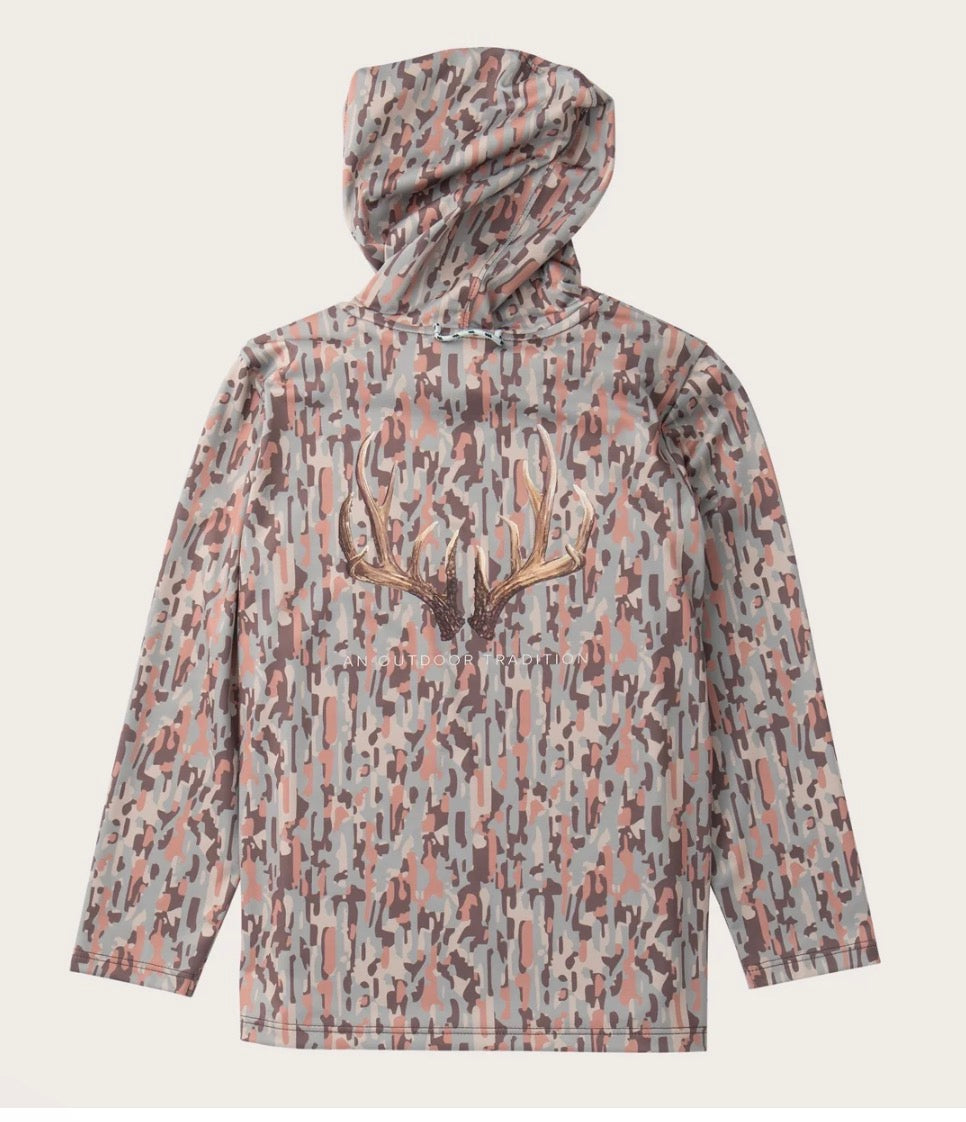 A hooded long-sleeve shirt with an abstract camouflage pattern in gray, pink, and brown, featuring a large antler graphic on the chest, shown against a light beige background.