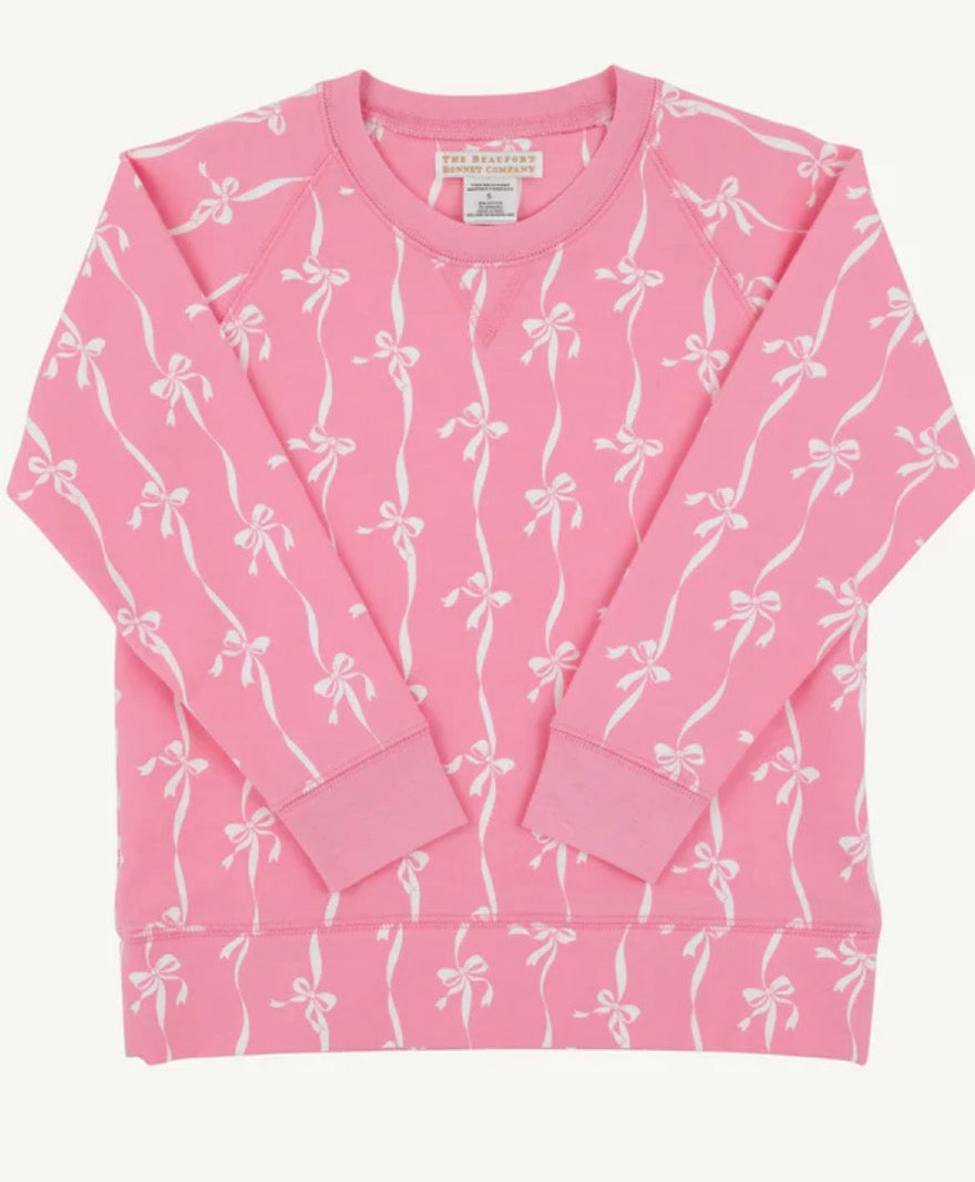 Pink sweatshirt with white bow pattern on a white background