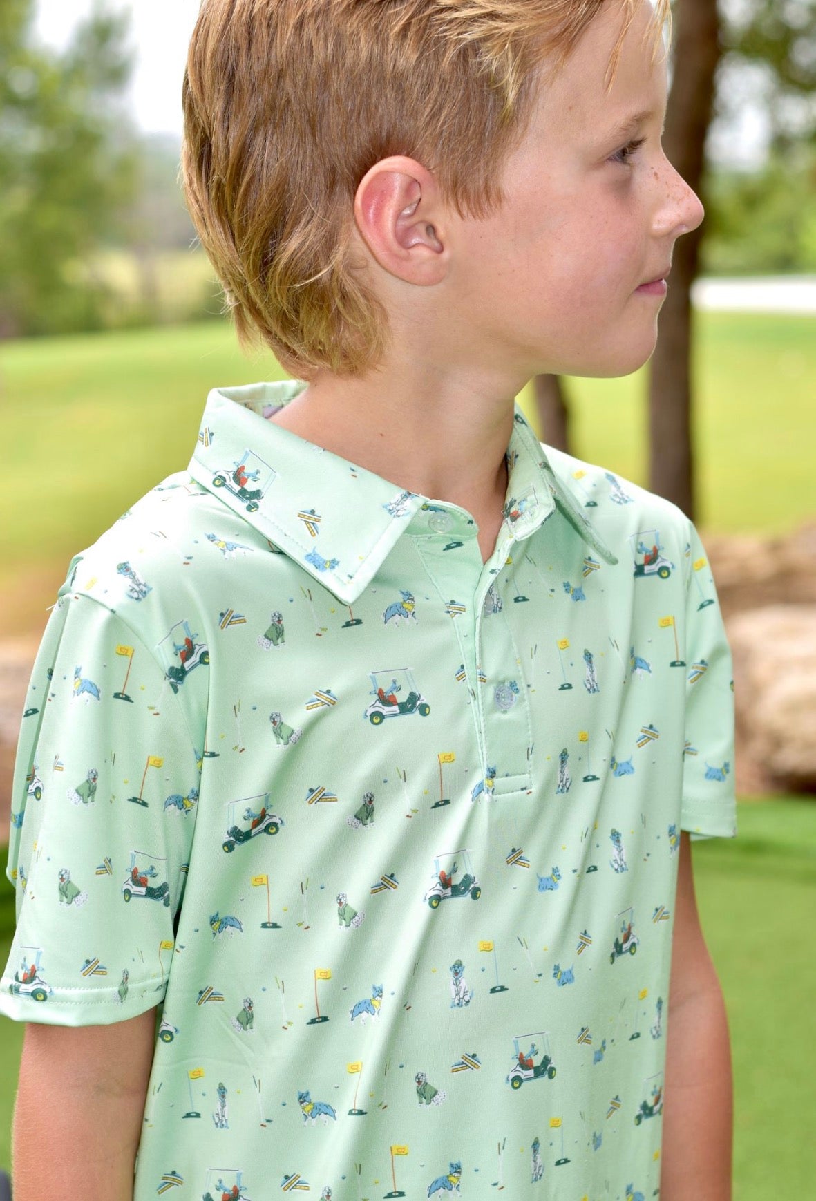 light green polo shirt with a  golf cart and golf items pattern 