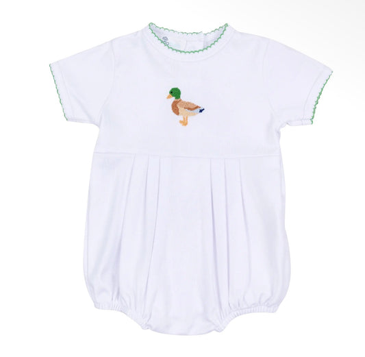 A white baby smocked romper with short sleeves, featuring a green and brown embroidered mallard duck on the chest and green scalloped trim along the neckline and sleeve cuffs.