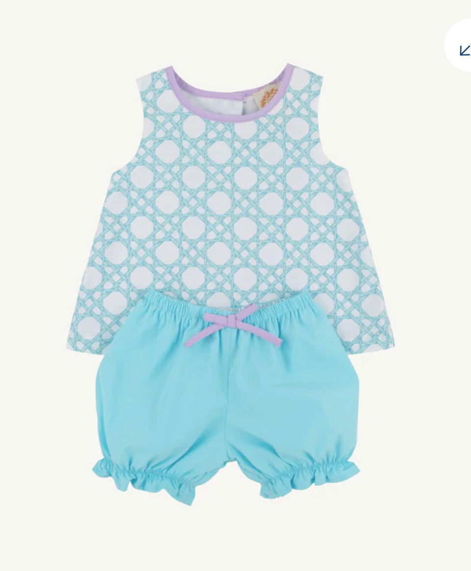 Baby outfit with polka dot top and light blue bloomers on a white background