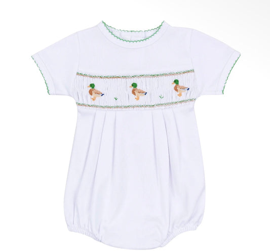 A white short-sleeve baby smocked bodysuit featuring a decorative horizontal band with three embroidered ducks and green trim along the collar and sleeve edges, shown against a plain white background.