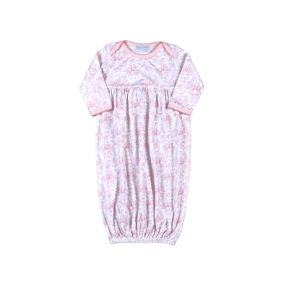 Infant gown with allover pink toile pattern, lap shoulder and long sleeves with pink trim.