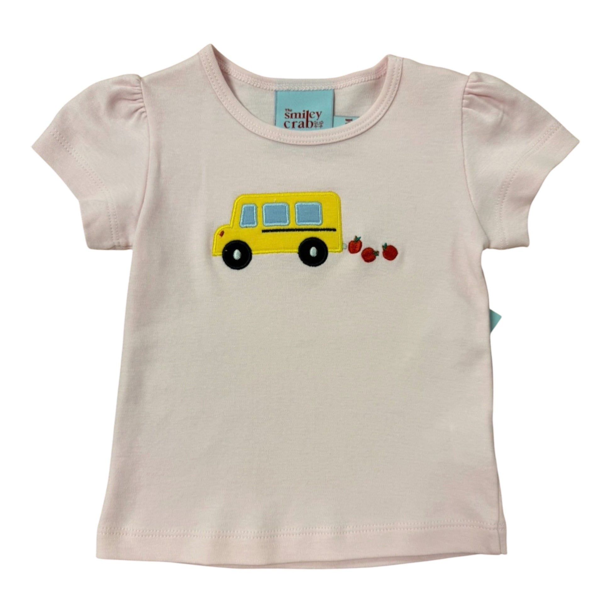 Pink t-shirt with a yellow school bus and red apples