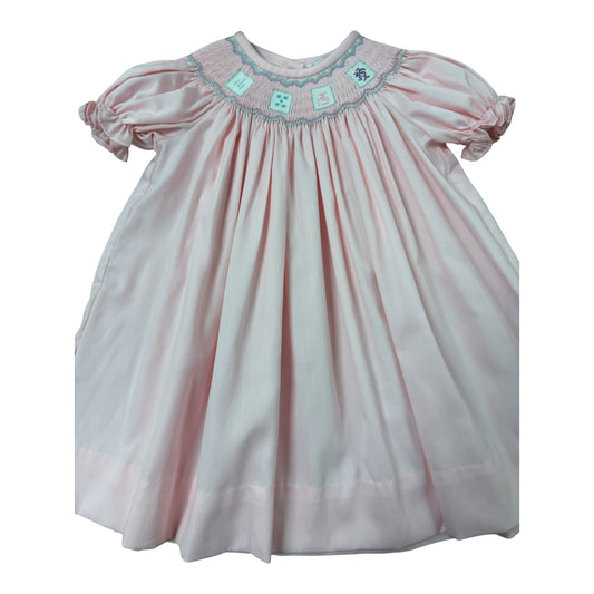 Light pink smocked dress with mahjong tiles design 