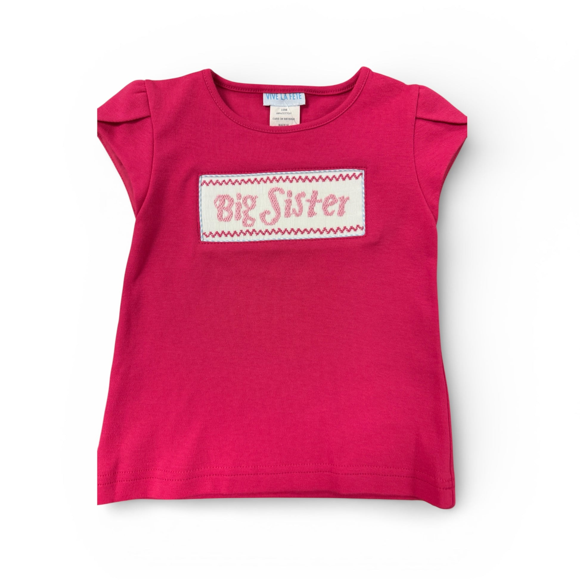 Pink  smoked shirt with 'Big Sister' text on a white background