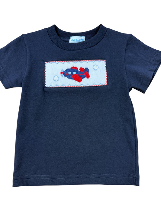 Navy blue smocked  shirt with a colorful airplane design on a white background