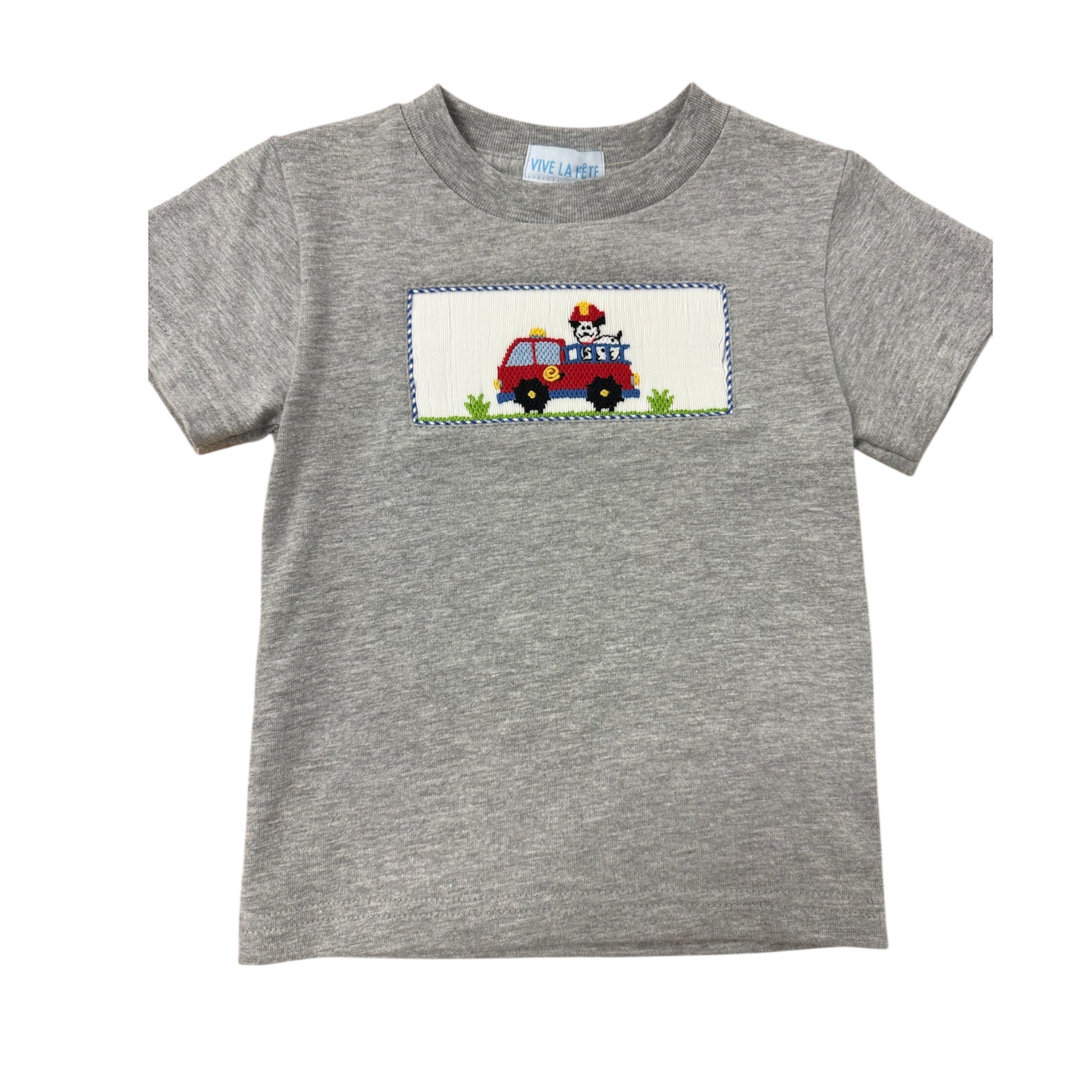 Gray smocked shirt with a fire truck design on a white background