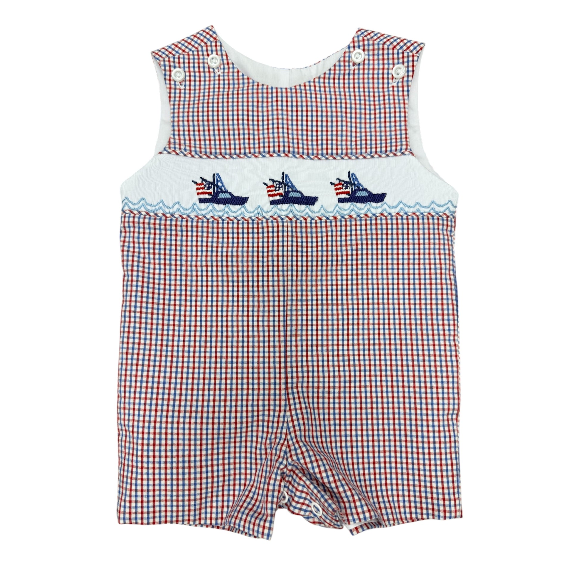 Red, white, and blue checkered smocked baby boy romper with embroidered boats on a white background